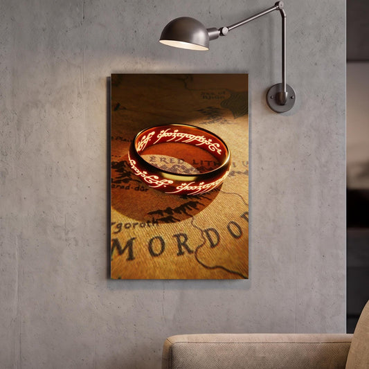 a ring with a red and gold design, which appears to be a piece of jewelry, displayed on a wall.