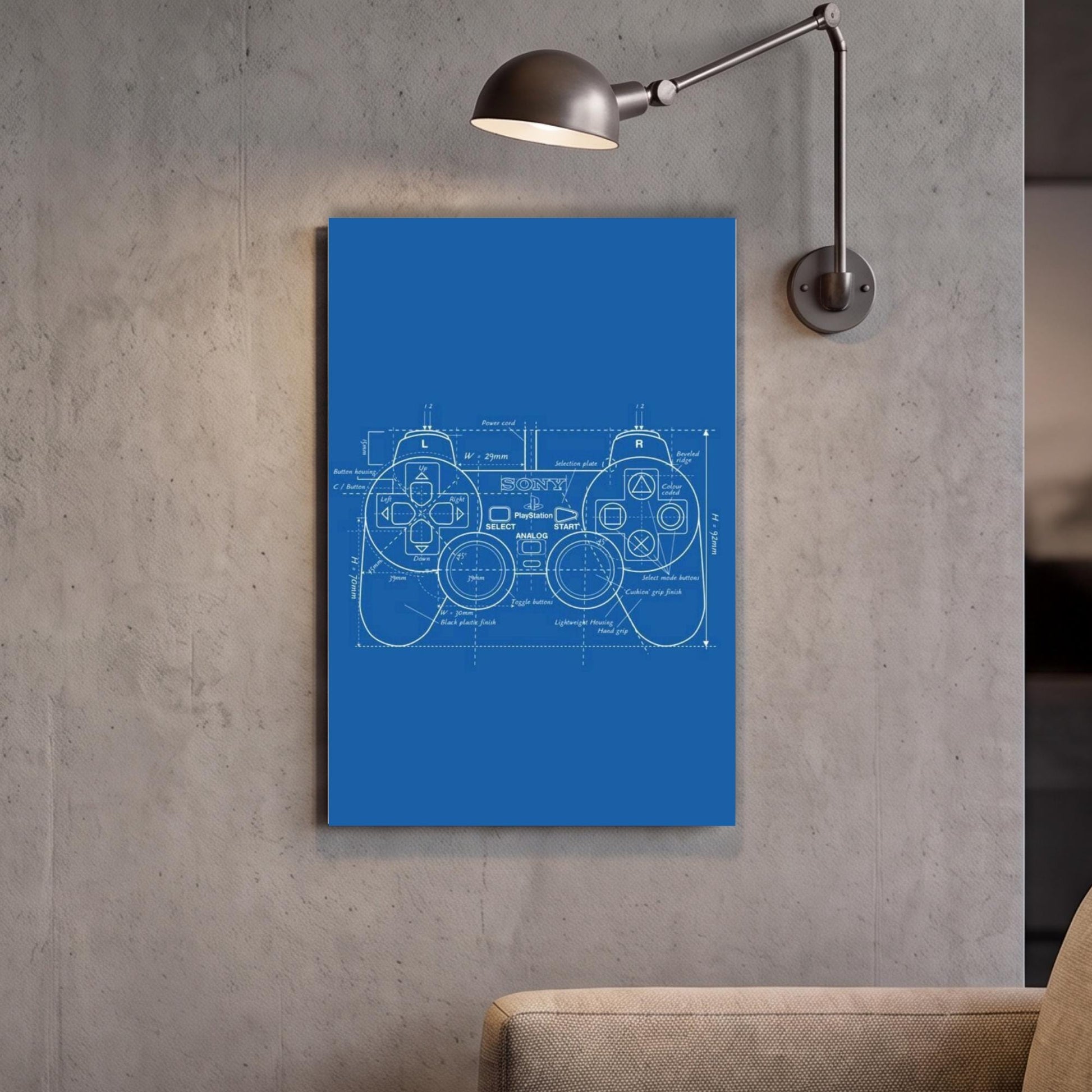 a blue canvas with a technical drawing of a joystick, mounted on a wall next to a light fixture.