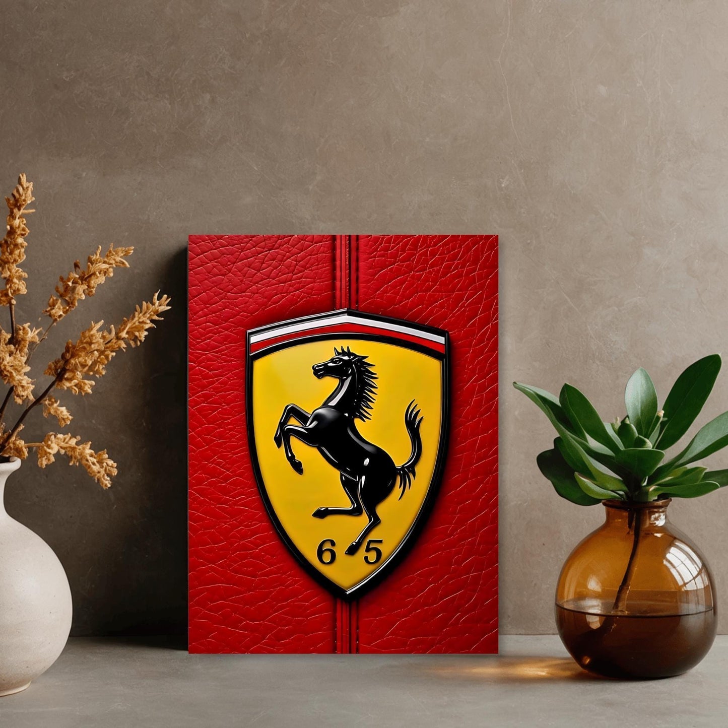 a red leather-like background with a yellow shield-shaped logo, which appears to be a Ferrari emblem, and a black horse rearing up on its hind legs. The logo is accompanied by the number "6" and "6.5" on the shield. The backdrop is set against a beige wall, and there are two vases on either side of the image, one containing dried flowers and the other holding a potted plant.