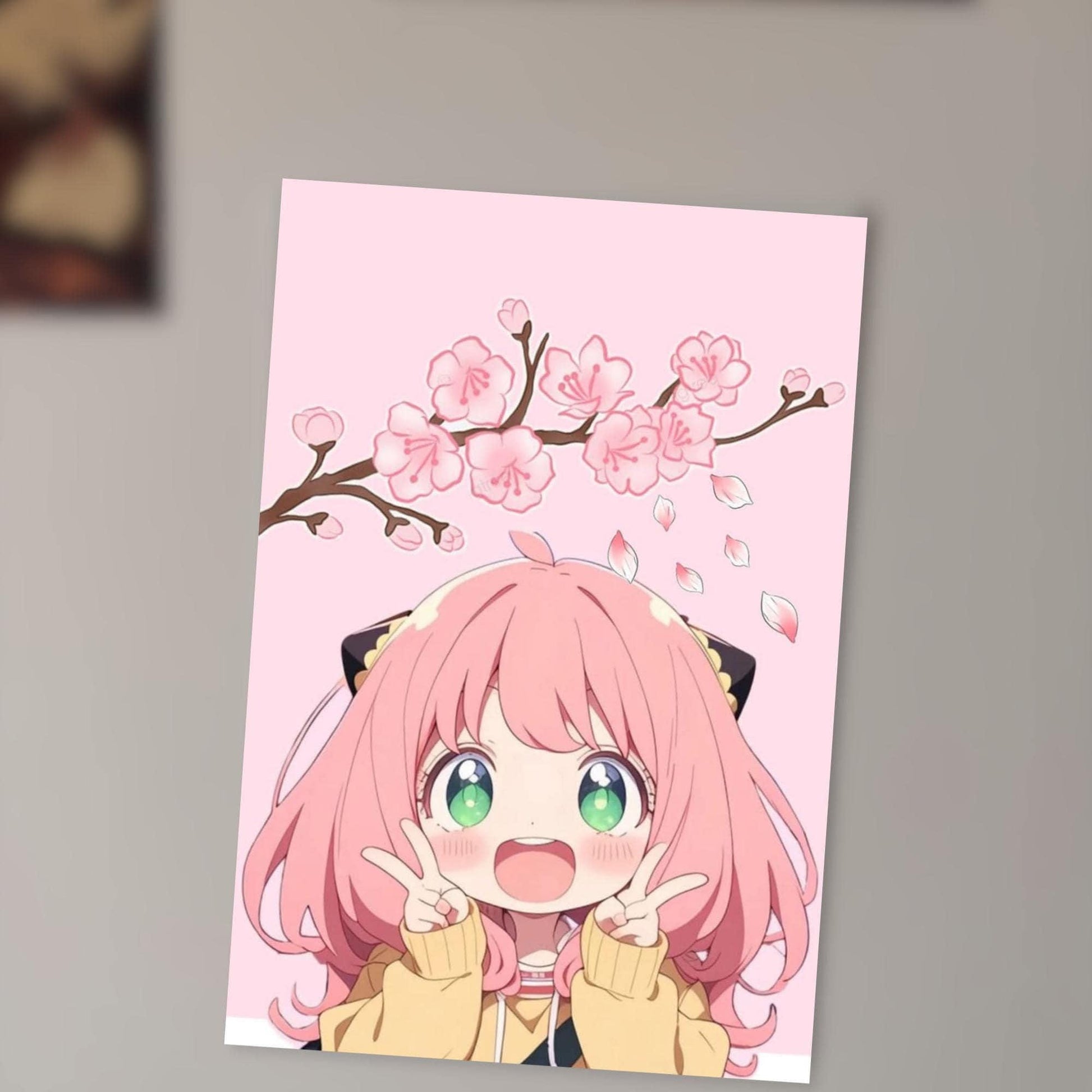 A young girl with pink hair and green eyes is smiling and making a peace sign with her hands, set against a pink background with pink flowers.