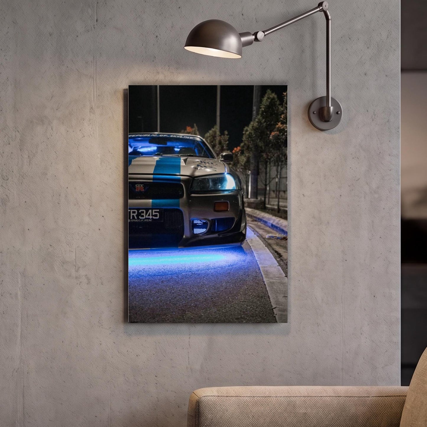 A framed photograph of a police car with blue lights on the front, mounted on a wall next to a lamp.