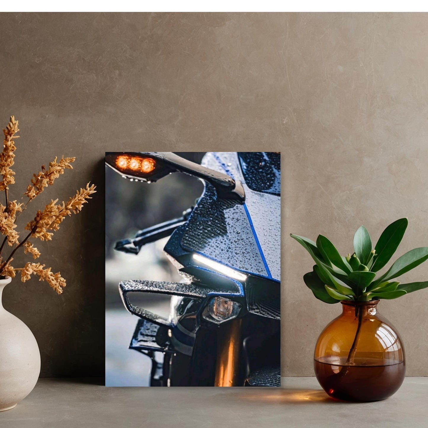 a close-up view of a motorcycle's handlebars, with a blurred background, and a vase of flowers and a potted plant on either side.